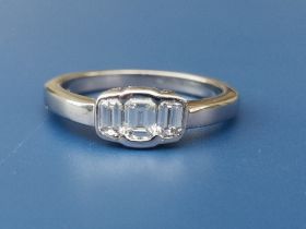 A modern rectangular cut three stone diamond 18ct white gold ring, London marks. Finger size M.