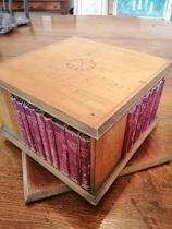 A small Edwardian inlaid mahogany revolving square bookcase, together with 39 books including sets