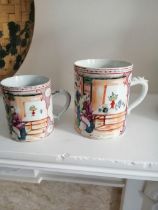 Two matching 19thC Chinese famille rose mugs decorated figures on terraces - one rim chip.