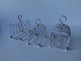 A Mappin & Webb silver toast rack, London 1919, 4.25", a Birmingham 1923 silver wire tost rack and a