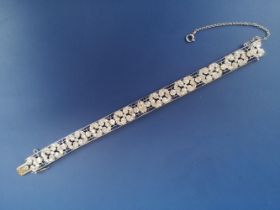 An Edwardian sapphire & diamond set panel bracelet, of openwork form, having numerous millegrain set