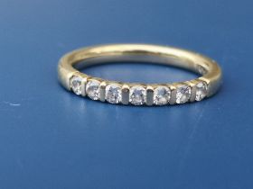 A small modern seven stone diamond half eternity style ring on 585 metal shank. Finger size L.