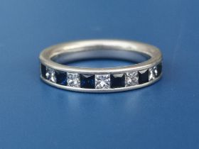 A sapphire & diamond calibre set platinum half eternity ring. Finger size M.