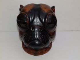 A late 19thC wooden bulldog head humidor/tobacco jar, the hinged cover with large glass eyes,