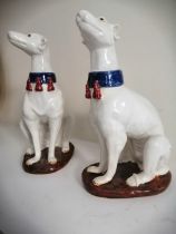 A pair of seated white glazed dogs with blue collars, 14" high (2)