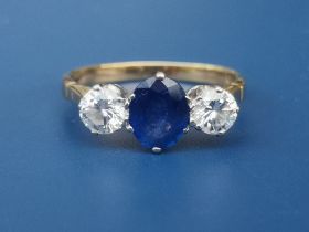A three stone sapphire & diamond ring on 18ct gold shank, London marks. Finger size Q.