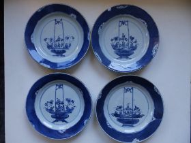 A set of four antique Chinese blue & white plates, each decorated with a basket of flowering plants,