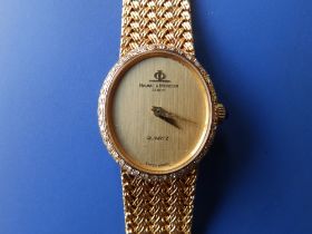 A lady's diamond set 18ct gold Baume & Mercier Quartz bracelet wrist watch with oval gold dial,