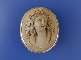 An antique lava ware cameo brooch modelled in high relief with a bacchanalian bust, 2" high - chip