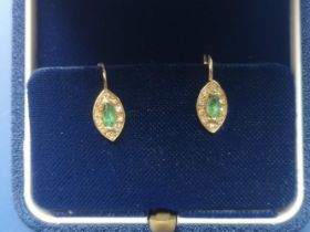 A pair of emerald & diamond marquise cluster earrings in 750 yellow metal, the setings 10mm