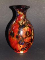 A Royal Doulton flambe vase, exhibiting a range of mottled coloured glazes - 'MG', 6.5" high.