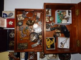 A wooden box of jewellery and other items.