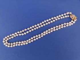 A twin strand baroque pearl necklace, average girth of pearls between 8 & 9mm, the diamond set 18c