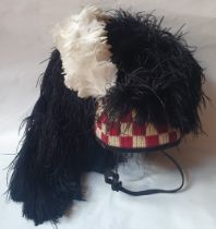 A Scottish military feather bonnet with four tails.