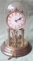 A German 'anniversary' clock under glass dome, 11.5" high.