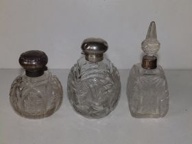 Three silver mounted cut glass scent bottles, the tallest 6.4" - bruising to silver.