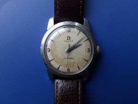 A gent's stainless steel Omega Seamaster with silvered dial, centre seconds, on Omega leather strap,