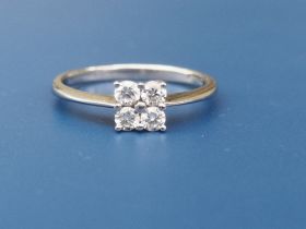 A modern diamond ring set with four small diamonds of total weight approximately 0.25 carat -