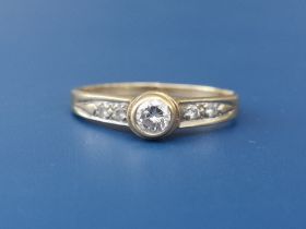 A small collet set diamond solitaire ring with diamond shoulders - shank cut. Finger size L.