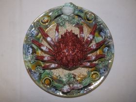 A Palissy ware circular wall plaque modelled with a crab, 9.5" diameter.