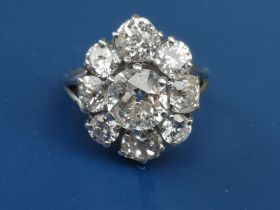 A large diamond set oval cluster ring, the central old cut stone surrounded by four old cuts and