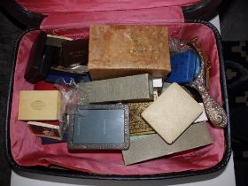 A small suitcase containing some lead farmyard figures, costume jewellery and collectors' items.
