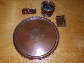 A circular Arts & Crafts copper tray and three other pieces. (4)