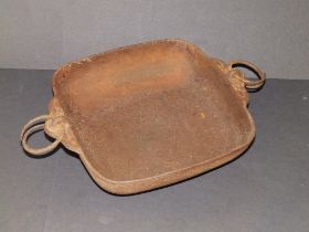 An Oriental rectangular iron dish, seal mark to underside, 10" across handle mouldings, - rusted.