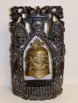 A Chinese brass bell in silver-inlaid naturalistic wooden stand, 19" high.