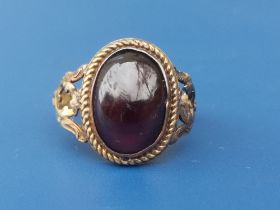 An antique 18ct gold ring set with a cabochon garnet, London marks - slight damage to shoulder