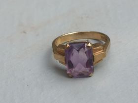 A rectangular cut amethyst solitaire ring on 9ct yellow shank. Finger size L.