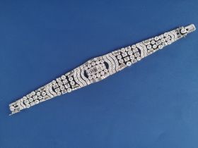 An art deco diamond set tapering panel bracelet, of openwork form having numerous collet set round &