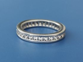 A diamond set white metal eternity ring. Finger size L.