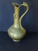 A bronze ewer, the cast decoration depicting a pair of swans/geese, the neck of one bird forming the