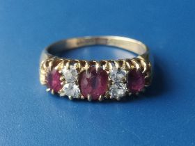 An Edwardian seven stone ruby & diamond set gold ring. Finger size K.