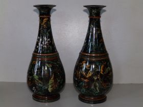 A pair of Doulton Lambeth 'faience' vases by Walter Gandy, decorated overall floqwering foliage on a