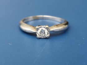 A modern small diamond illusion set solitaire ring in white metal - shank cut. Finger size N.