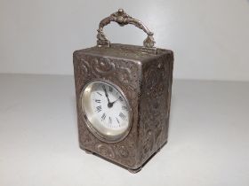 A late Victorian Mappin & Webb embossed silver cased carriage clock with French movement - London
