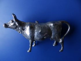A Berthold Muller silver cow creamer, naturalistically modelled, wearing a collar, an insect