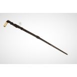 WITHDRAWN - An early 20th century Polynesian intricately carved walking stick with a bone handle,