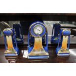 Ceramic mantle clock with matching vase garnitures,