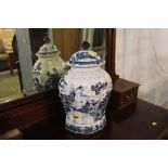 Large lidded oriental blue and white scalloped vase. Height 46 cm.