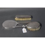 Silver mirror and two silver brushes,