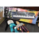 Electronic keyboard and two dolls