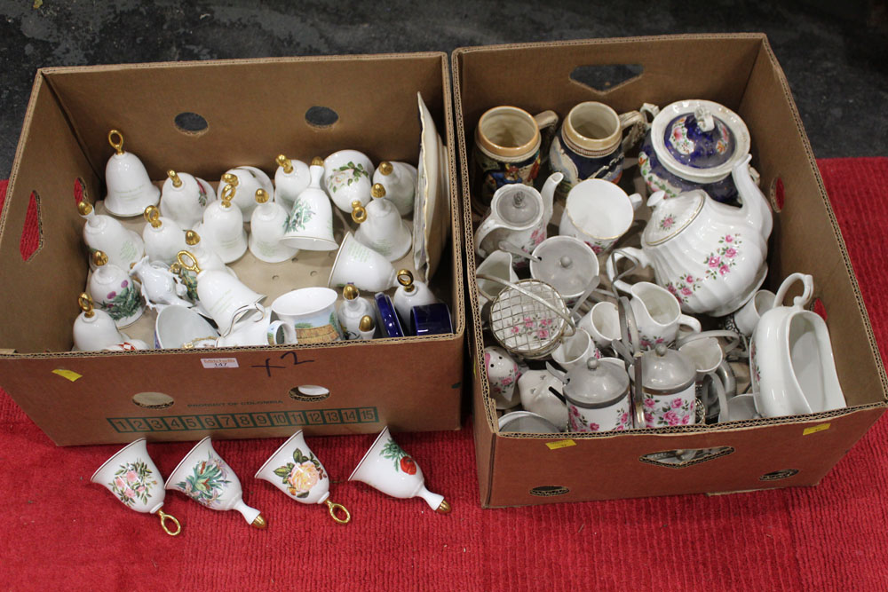 Two boxes of china, ornamental bells, decorative plates, teapots,