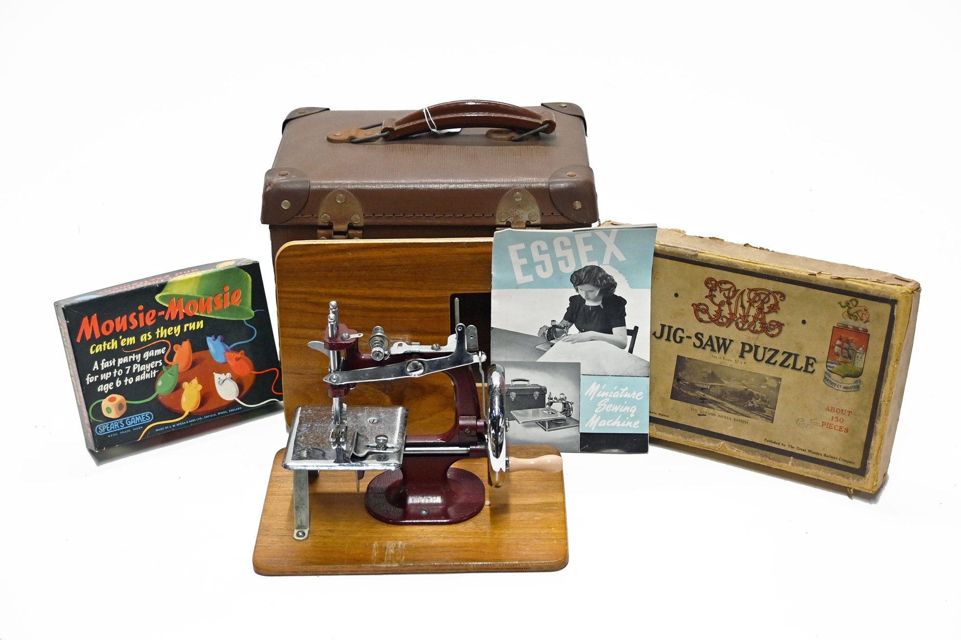An Essex miniature sewing machine with cardboard box and case,