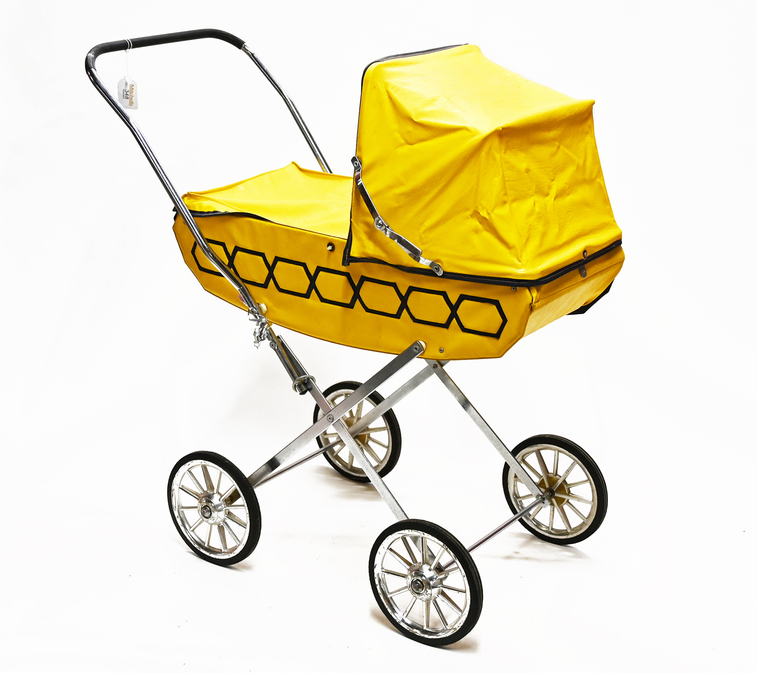 A vintage child's toy pram with yellow body
