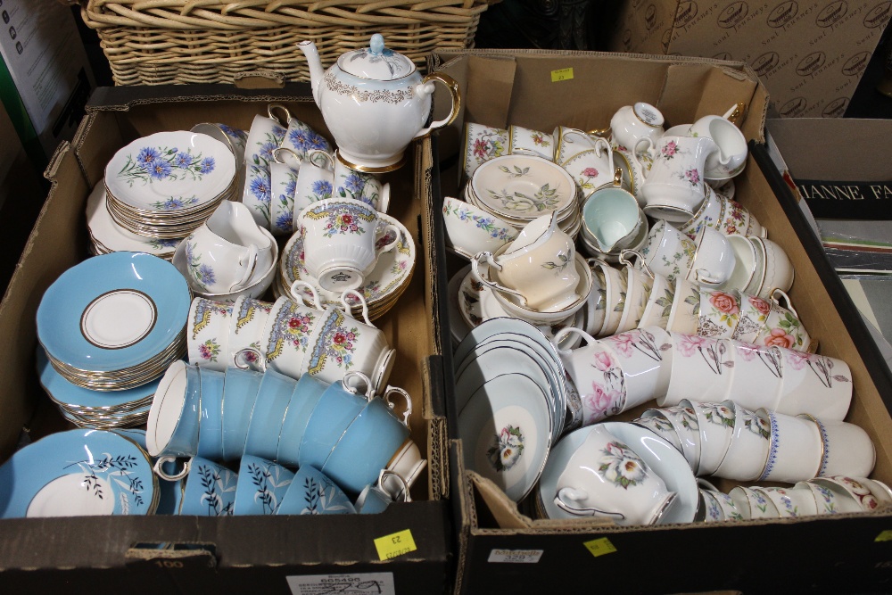 Two boxes of mixed patterned teacups and saucers, teapots, milk jug,