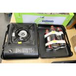 Gas range camping stove and four gas canisters