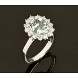 An 18 ct gold aquamarine and diamond cluster ring, aquamarine +/- 2.21 carats, diamonds +/- .